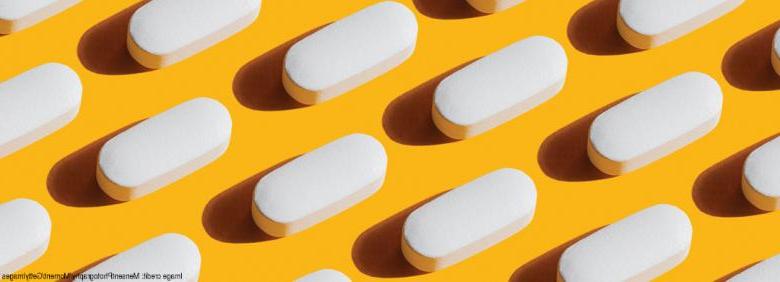 image of neatly organized pills on yellow background