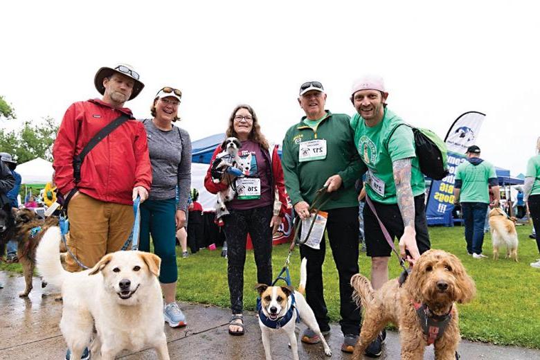 Group photo of Health District employees, former employees, family members, and dogs at the LArimer Humane Society's Fire Hydrant 5K